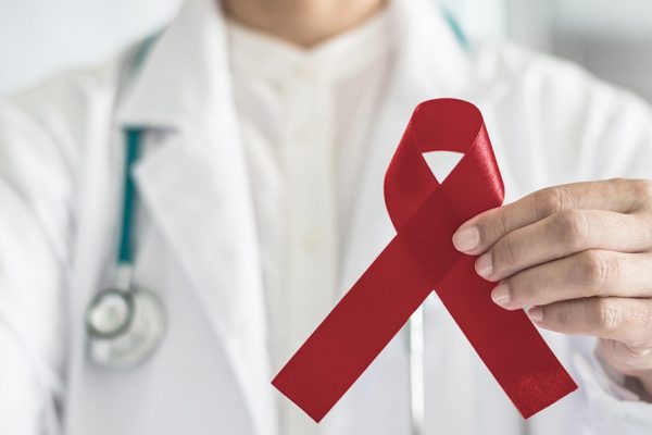 doctor holding burgundy multiple myeloma ribbon