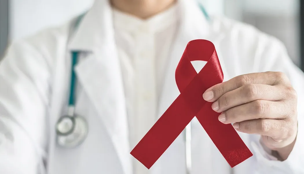 Improvements Continue to trend upward for Multiple Myeloma Prognosis doctor holding burgundy multiple myeloma ribbon