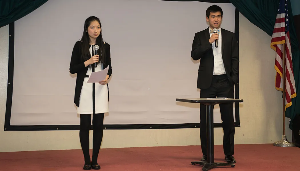 Tina Zhang and her Youth Art Bridge Teammate address the audience at their fundraiser for cancer research