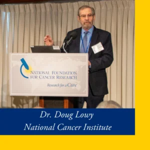 Dr. Doug Lowy Speaking Behind a Podium