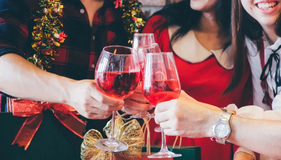 Christmas party cheerful young friends drink wine responsibly