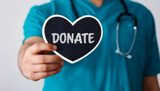 Nurse Doctor Holds a Heart That Says Donate