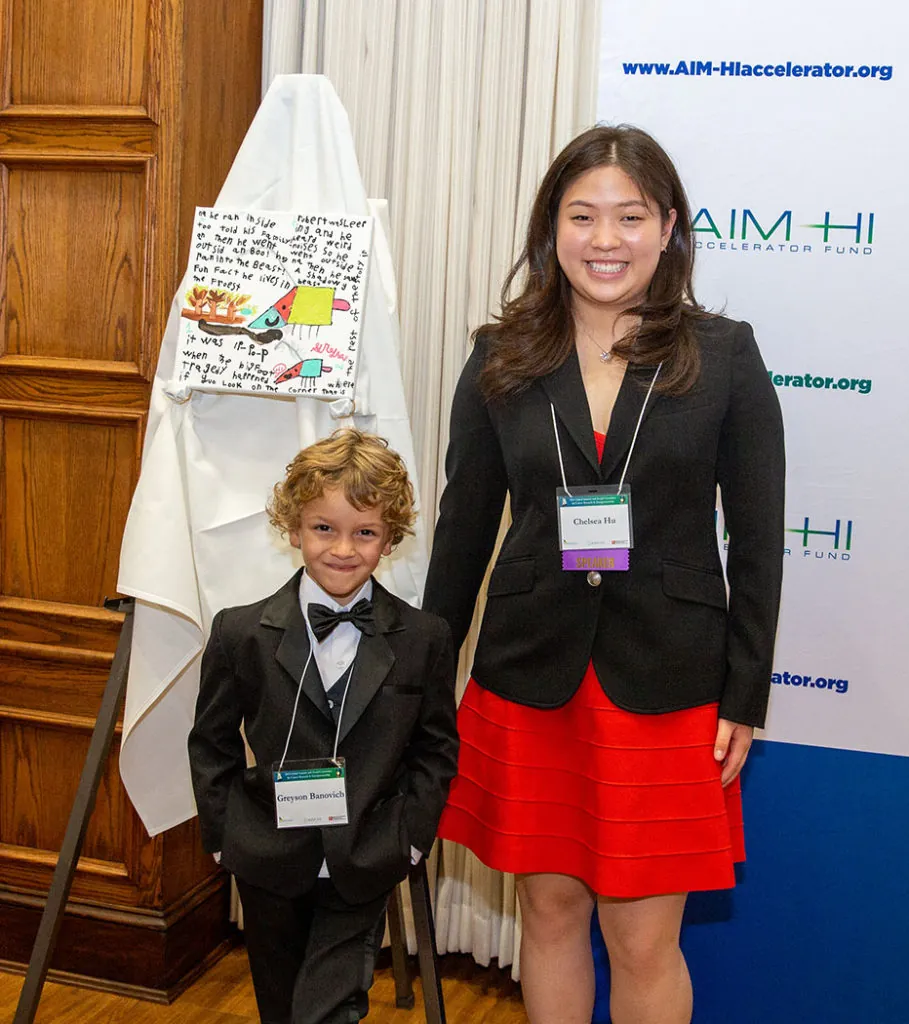 Greyson Banovich poses with his artwork and Teen Mobile Arts Founder, Chelsea Hu